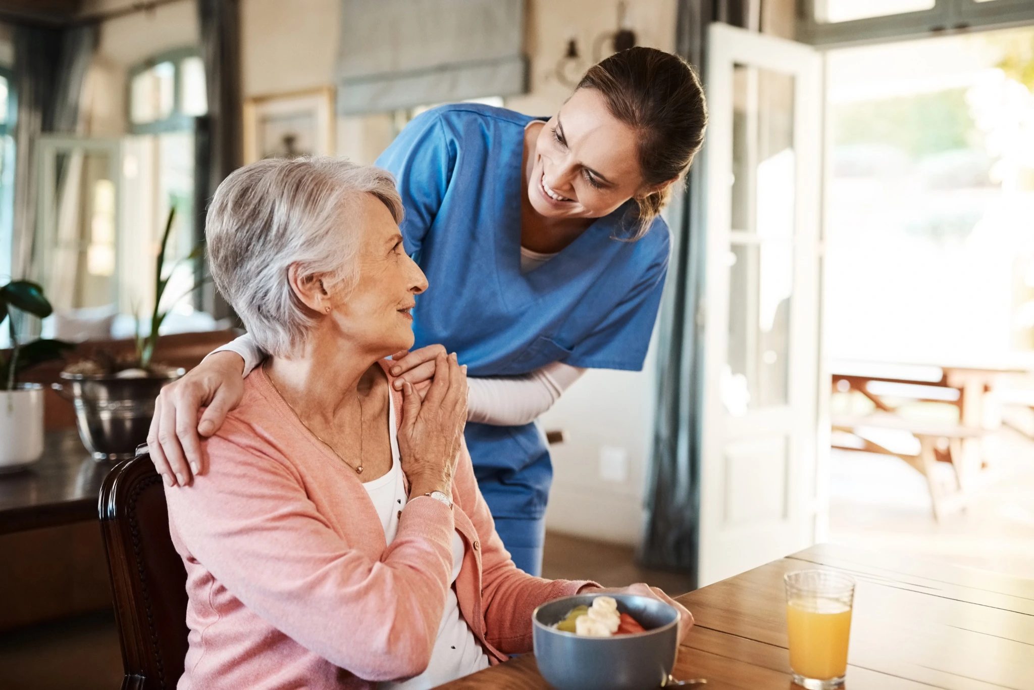 Care worker speaking with a patient at home